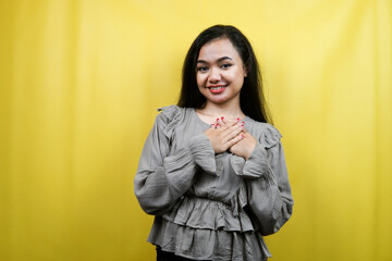 Beautiful young woman, with hands holding chest, isolated