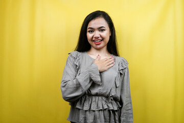 Beautiful young woman with hands holding chest isolated