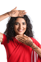 Beautiful Indian woman with henna tattoo on white background