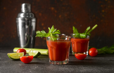 Glass of bloody mary with celery, lime and tomatoes on table © Pixel-Shot