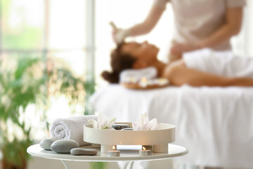 Beautiful spa composition with stones on table in salon