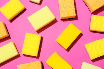 Yellow cleaning sponges on color background