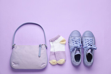 Stylish bag, shoes and socks on color background