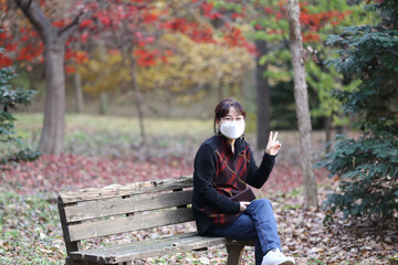 Fototapeta premium Korean woman enjoying autumn leaves