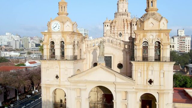 Aerial dolly in shot capturing the Catedral In Cordoba, toward the statue of Christ the King on cathedral roof during daytime.