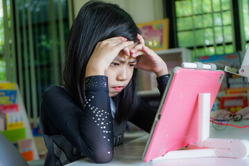Stressed girl using tablet for online learning  class at home. Home isolation, Covid19...