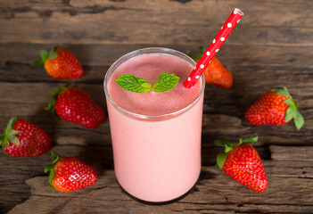 Strawberry yogurt fruit juice smoothie pink colorful fruit juice milkshake blend beverage healthy high protein the taste yummy In glass drink episode morning on wood background.