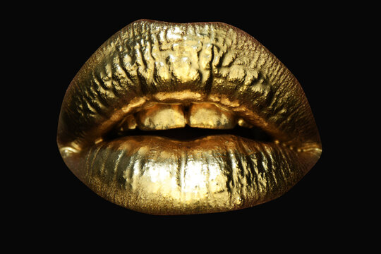 Golden lipstick on lips, female gold mouth. Imprint lips. Luxury cosmetics for women. Golden effect on the lips.