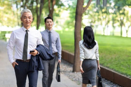 Confident business people walking outdoors