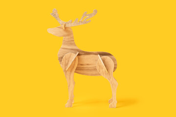 Wooden reindeer on yellow background