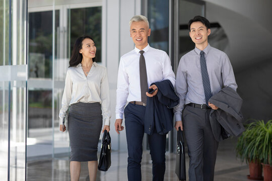 Confident business people walking