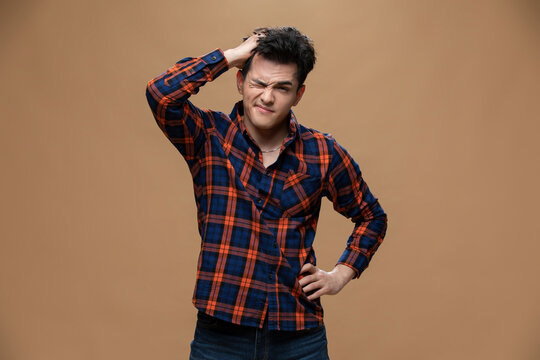 Studio shot of anxious young Chinese man