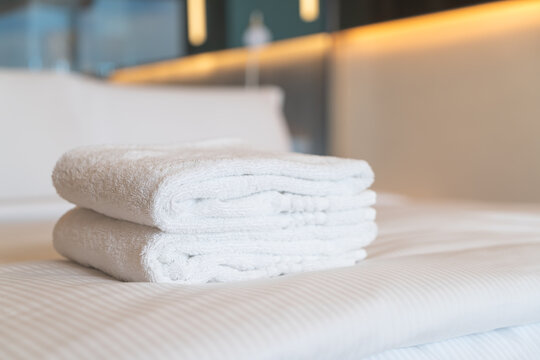 white shower towel on bed