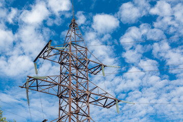 Power line, power line, high-voltage overhead power line pylon, sky with clouds.