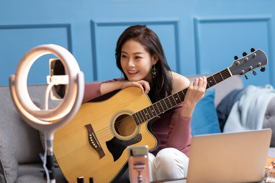 Young Chinese woman doing live webcast at home
