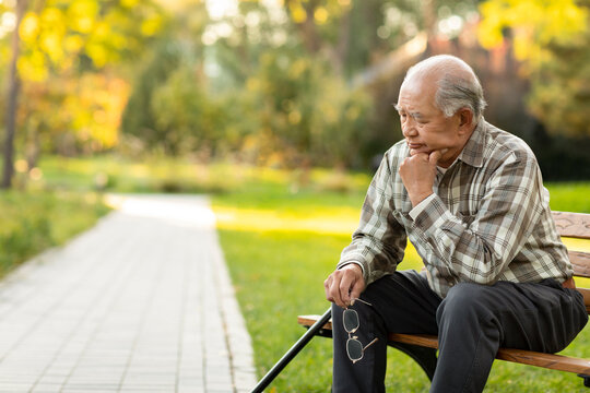 Lonely senior man thinking in the park