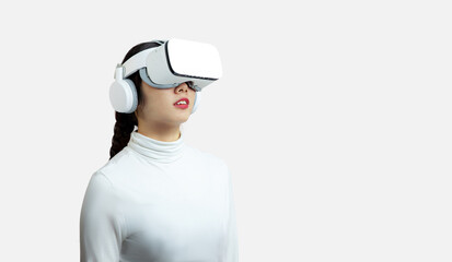 Metaverse VR concepts, asian woman wearing virtual reality glasses and looking at something on the white background. 