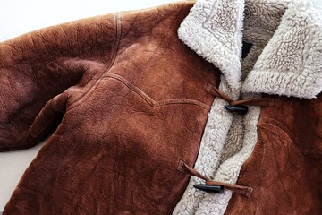 Close up of old brown and white fur sweater