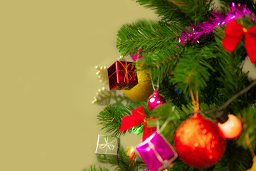 Christmas Tree with colorful decoration on cream background, holidays concepts