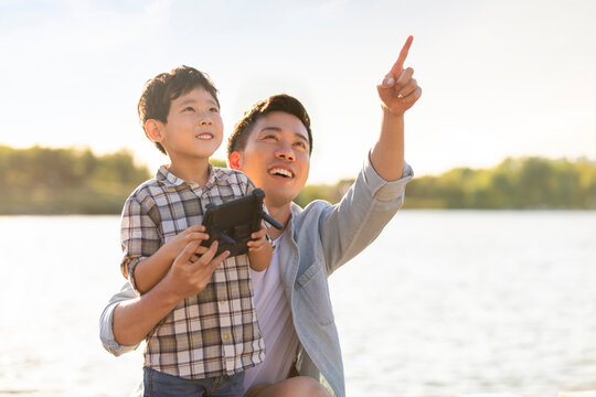 Happy father and son playing with remote control toy