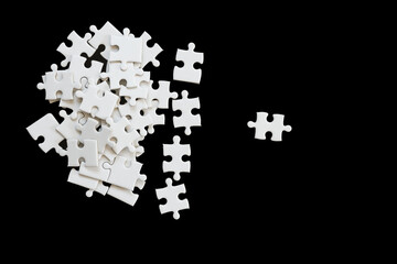 White jigsaw puzzle on black background.