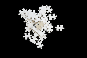 White jigsaw puzzle on black background.