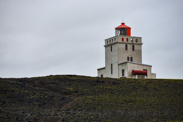 Fototapeta na wymiar Typically overcast sky above Dyrhólaey Lighthouse, which marks the southernmost point of mainland Iceland