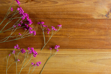 A purple flowers on wooden background with copy space.