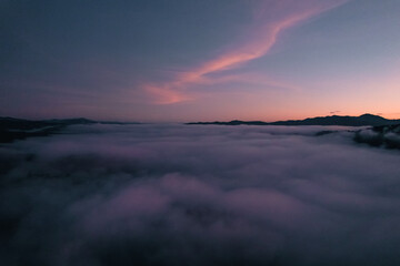 Flying above the clouds sunrise and fog
