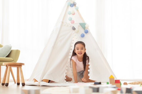Cute Chinese girl playing in tent