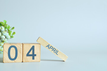 April 4, Calendar cover design with number cube with green fruit on blue background.