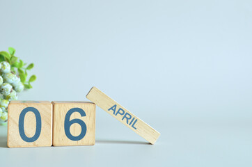 April 6, Calendar cover design with number cube with green fruit on blue background.