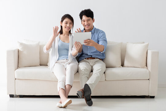 Cheerful young couple using digital tablet