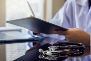 Doctor using digital computer.