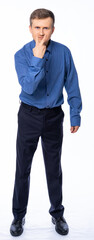 a man in the studio on a white background in trousers and a shirt shakes his fingers