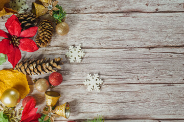 Christmas frame with white and black checked buffalo plaid ribbon, baubles and tree branches. Top view on a rustic wood background.