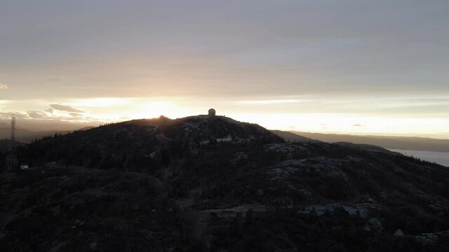 Dazzling Sun Shining Over Summit Of Grakallen Mountain In Norway. - aerial