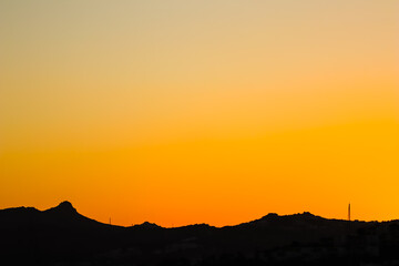 Background from a beautiful colorful sunset with the silhouette of the mountains. High quality photo