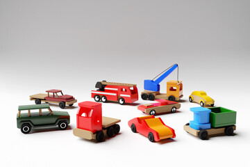 3d illustration of kids toys of a multicolored car, jeep, convertible, dump truck, truck and crane on a white isolated background. Eco-friendly toy for parents and children