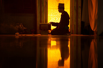 Obraz na płótnie Canvas Muslim man praying the Holy Quran In the mosque that is the teaching of the Prophet Muhammad
