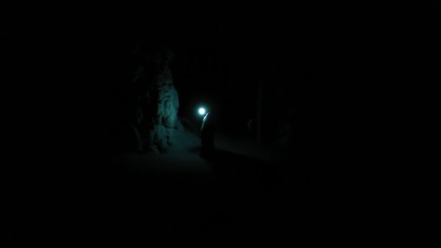 Santa in magical night forests of Lapland with a lantern in hand - Aerial, drone view