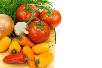 Fresh vegetables and greens on the board, food close up. Group of fresh vegetables on wooden table.