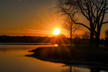Sunset over the lake near the river 