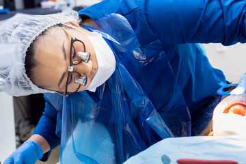 dentist treats teeth of kid with oral dilator at appointment. treatment of teeth