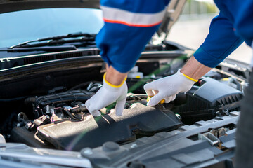professional mechanic working in the auto service fixing car problems, work under the hood
