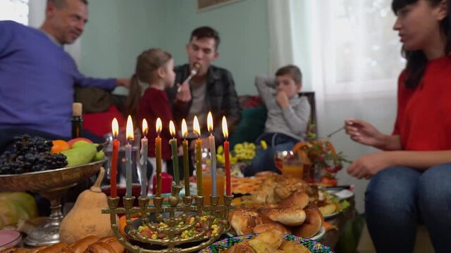 Happy Jewish Family Celebrates Hanukkah. Festival of Lights. Israel people. Festive dinner together. The Hanukkah menorah