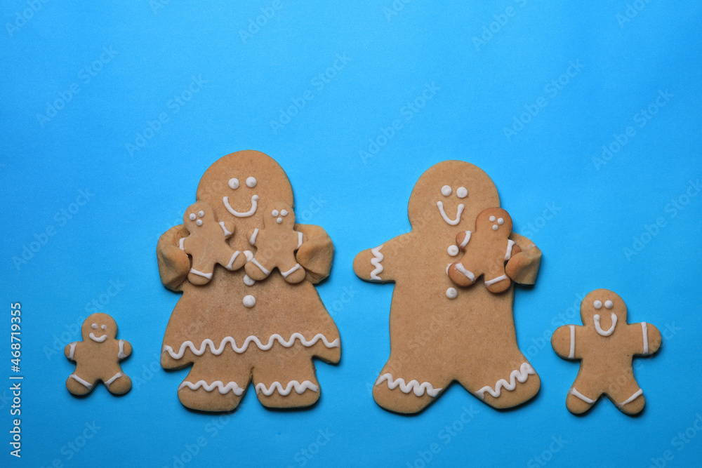 Wall mural Smiling GingerBread People on Blue Background