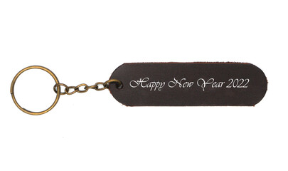 Leather keychain with Happy new yaer 2022 word isolated on white background. Brown Color , Happy...