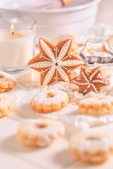 Homemade Christmas gingerbread and cookies with baking ingredients in white