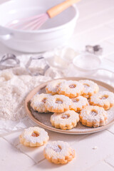 Homemade Christmas cookies with baking ingredients in white